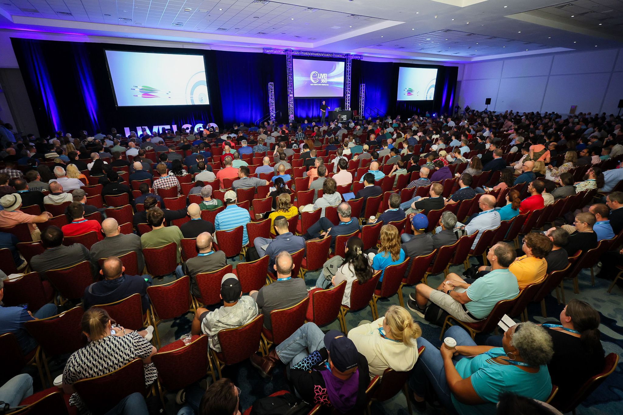 A packed Live! 360 keynote ballroom with three projection screens and large LIVE! 360 letters on the stage.